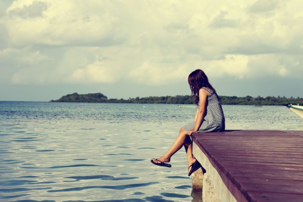 woman sitting at edge of the pier looking down into the water We're strong and capable, but somewhere along the line we bought into the nonsense that strong means silent.